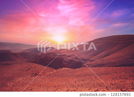 Evening cloudy sky over mountain desert. Negev desert in Israel at sunset Evening cloudy sky over mountain desert. Negev desert in Israel at sunset 128157691