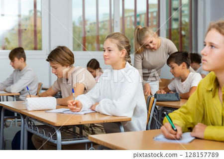 Young boys and girls studying in classroom Young boys and girls studying in classroom 128157789