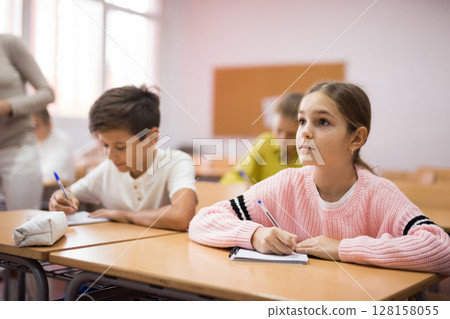 Group of school kids and teacher during lesson Group of school kids and teacher during lesson 128158055