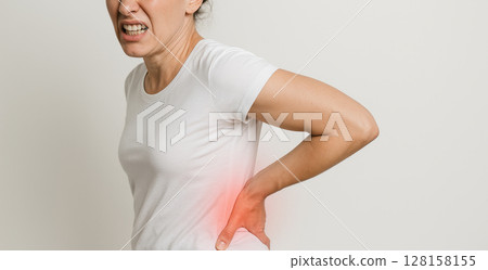 Woman pain back pain discomfort ache health injury white shirt adult female isolated expression suffering hurt body casual human person side studio adult only one person upper body indoors 128158155