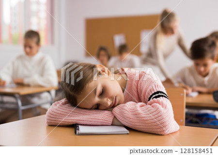 Young girl sleeping during lesson 128158451