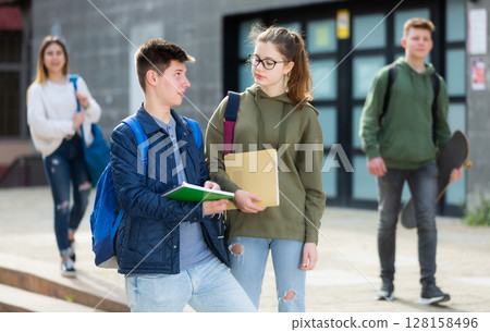 Teenage students talking outside after lessons 128158496