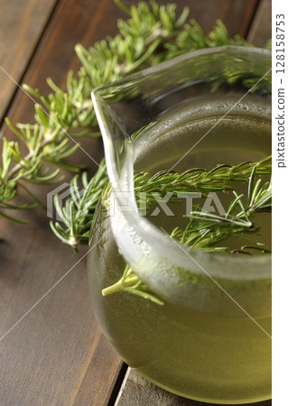 Teapot with rosemary leaves and herbal tea Teapot with rosemary leaves and herbal tea 128158753