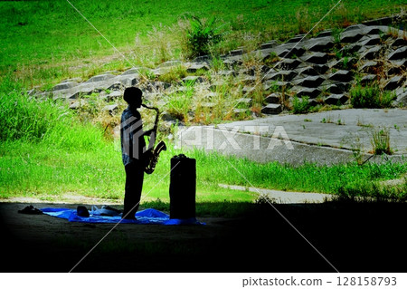 Young man practicing the saxophone 128158793