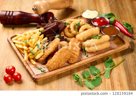 Beer Snack Board with Fries, Mini Sausages, Chicken Whips, Onion Rings 128159184