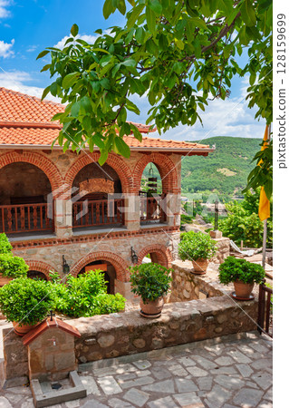 Brick and stone monastery building with potted plants  in Meteora Greece 128159699