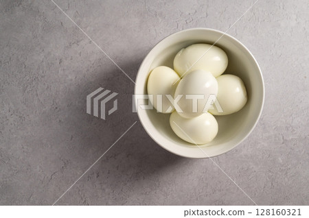 Hard boiled eggs in a bowl, protein food, copy space 128160321