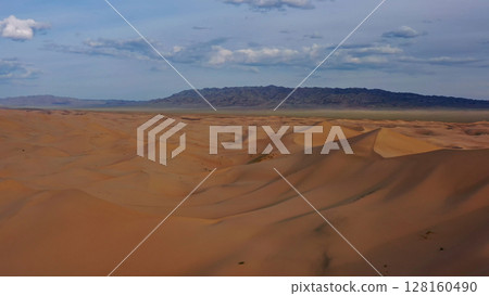 Aerial view of sand dunes in desert at sunset Aerial view of sand dunes in desert at sunset 128160490