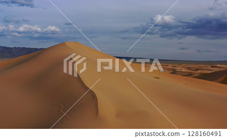 Aerial view of sand dunes in desert at sunset Aerial view of sand dunes in desert at sunset 128160491