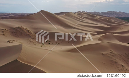Aerial view of sand dunes in desert at sunset Aerial view of sand dunes in desert at sunset 128160492