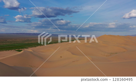 Aerial view of sand dunes in desert at sunset Aerial view of sand dunes in desert at sunset 128160495