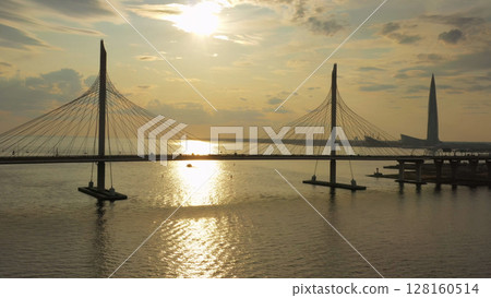 Cable-stayed bridge and new skyscraper at sunset Cable-stayed bridge and new skyscraper at sunset 128160514