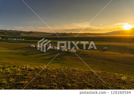 Landscape with yurts and mountains at sunset 128160584