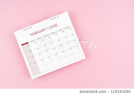 February desk calendar for 2026 year on pink background for schedule to make appointment meeting. February desk calendar for 2026 year on pink background for schedule to make appointment meeting. 128161092