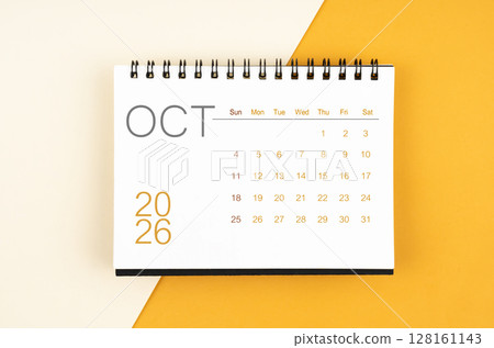 Desk calendar for October 2026 year on yellow color background, Flat lay. 128161143