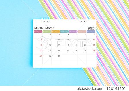 March 2026 desk calendar on blue and rainbow color background. 128161201