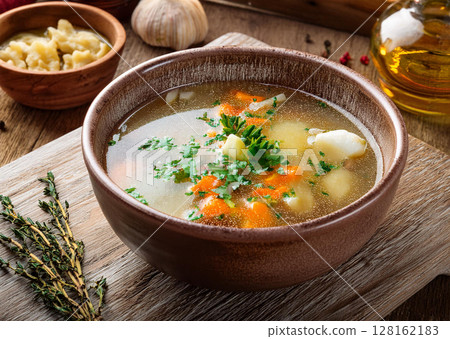 Delicious Clear Soup with Fresh Herbs 128162183