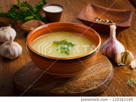 Delicious Clear Soup with Fresh Herbs 128162189