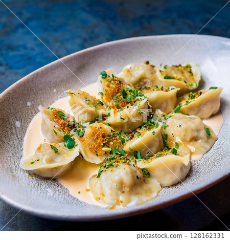 Elegant Dumplings with Creamy Herb Sauce 128162331