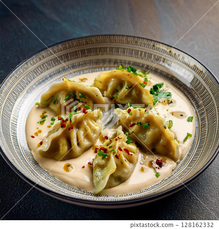 Elegant Dumplings with Creamy Herb Sauce 128162332