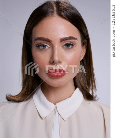 Elegant Young Woman in Professional Attire 128162612