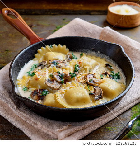 Creamy Ravioli Dish in Rustic Skillet 128163123