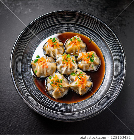 Delicious Asian Dumplings on Dark Plate 128163421