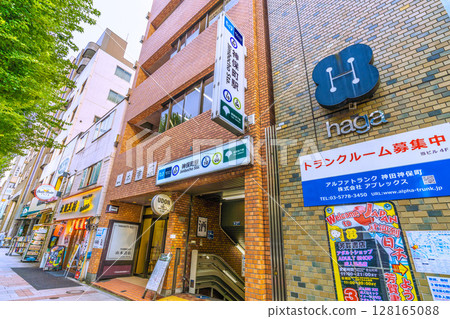 Tokyo cityscape in Japan: Kanda Jinbocho, a used bookstore district lined with shops facing north, Jimbocho Station. A bar is located under the stairs... = July 4th 128165088