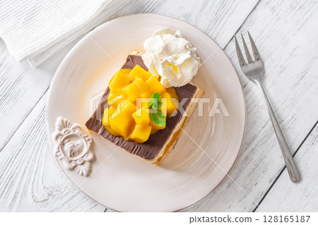 Square Mango Cheesecake With Chocolate Glaze, Fresh Cubes, and Whipped Cream 128165187