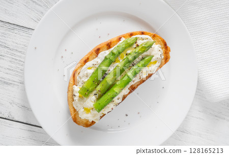 Grilled sandwich with white bread, stracciatella cheese, and green asparagus Grilled sandwich with white bread, stracciatella cheese, and green asparagus 128165213