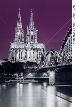Cologne, Germany. Night View Of Cologne Cathedral And Hohenzollern Bridge. Catholic Gothic Cathedral In Night Lighting. UNESCO. Black, White And Ultra Violet Colors 128165286