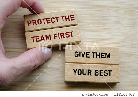 Protect the team first and give them your best text on wooden blocks, reinforcing the idea that effective leadership involves serving and uplifting others consistently Protect the team first and give them your best text on wooden blocks, reinforcing the idea that effective leadership involves serving and uplifting others consistently 128165468
