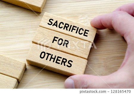 Sacrifice for others phrase on wooden blocks, leadership expectation and respect concept Sacrifice for others phrase on wooden blocks, leadership expectation and respect concept 128165470