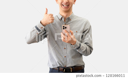 A man holding a smartphone and making a thumbs up pose A man holding a smartphone and making a thumbs up pose 128166011