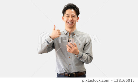 A man holding a smartphone and making a thumbs up pose A man holding a smartphone and making a thumbs up pose 128166013