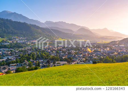 Sunrise casts a warm glow over Schladming, highlighting the charming architecture and lush landscapes of this beautiful Austrian town nestled in the Low Tauern mountains. 128166343