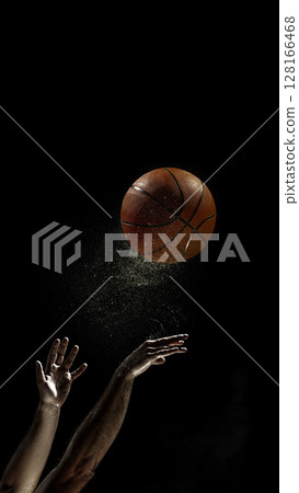 Basketball shot in mid-air with player's arms extended 128166468
