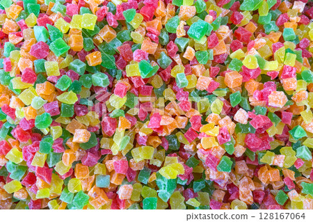 A colorful assortment of small, cubed candied fruits in vibrant shades of green, red, yellow, and orange 128167064