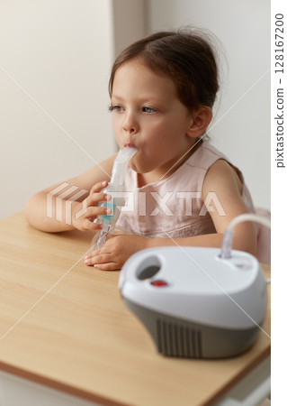 cute little toddler girl inhaling medicine on nebulizer and holding it on her own, portable inhaler for home cute little toddler girl inhaling medicine on nebulizer and holding it on her own, portable inhaler for home 128167200