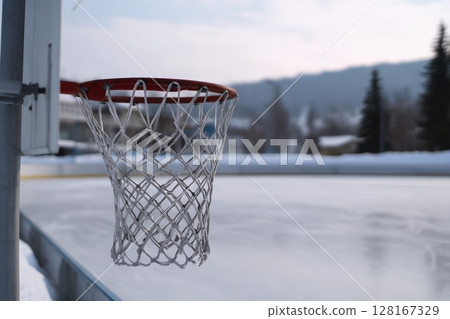 Winter basketball hoop near an ice rink in a snowy landscape 128167329