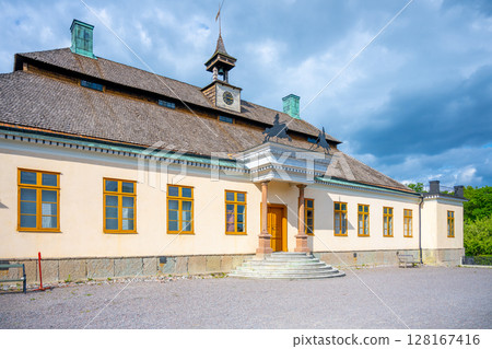 Skogaholm Manor stands proudly under a bright blue sky, showcasing its traditional Swedish architecture and the tranquility of Skansens open-air museum in Stockholm during summer. Sweden Skogaholm Manor stands proudly under a bright blue sky, showcasing its traditional Swedish architecture and the tranquility of Skansens open-air museum in Stockholm during summer. Sweden 128167416