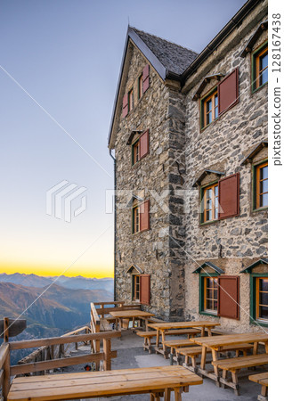Julius Payer House is illuminated by a vibrant sunset, surrounded by the majestic Ortler Alps. This historic guesthouse offers stunning views and a peaceful atmosphere for visitors. Julius Payer House is illuminated by a vibrant sunset, surrounded by the majestic Ortler Alps. This historic guesthouse offers stunning views and a peaceful atmosphere for visitors. 128167438
