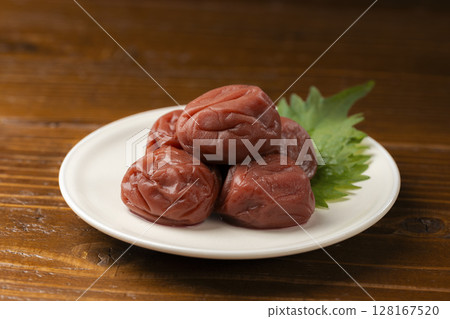 Pickled plums and shiso leaves on a plate Pickled plums and shiso leaves on a plate 128167520