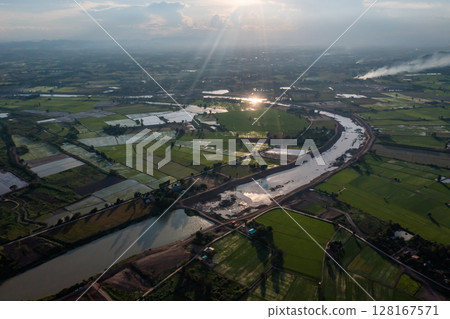 Construction dredges up for a canal and dam, to prevent a flood in the rainy season. Date on 14 May 2021 at Uthai Thani province, Thailand. 128167571
