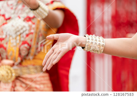 Close up hand of Thai folk dance during celebration on temple background. Thai traditional dance on event celebration. 128167583