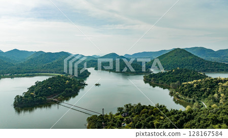 Kaeng Krachan dam with lake view and many green moutain, blue sky background. Kaeng Krachan Dam national park, Phetchaburi province, Thailand in aerial view from drone. Kaeng Krachan dam with lake view and many green moutain, blue sky background. Kaeng Krachan Dam national park, Phetchaburi province, Thailand in aerial view from drone. 128167584