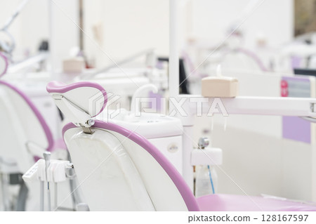 Many modern dental equipment and seats in a hygiene and sterile dental training room in the hospital. Many modern dental equipment and seats in a hygiene and sterile dental training room in the hospital. 128167597
