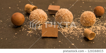 Homemade chocolate bonbons handmade at home dipped in natural coconut Homemade chocolate bonbons handmade at home dipped in natural coconut 128168015