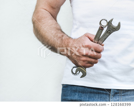 Attractive man, hand tools and work clothes Attractive man, hand tools and work clothes 128168399