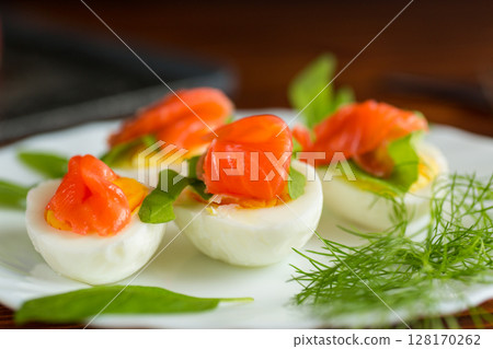 Decorated eggs with red fish and herbs on the table Decorated eggs with red fish and herbs on the table 128170262